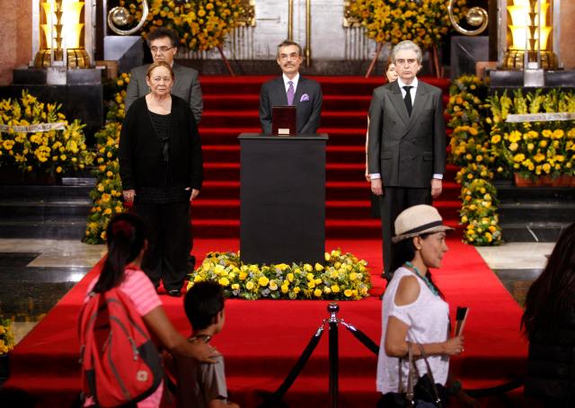 Mercedes Barcha and her sons Rodrigo Garcia Barcha and Gonzalo Garcia Barcha stand next to an urn containing Garcia Marquez' ashes for public viewing in the Palace of Fine Arts in Mexico City