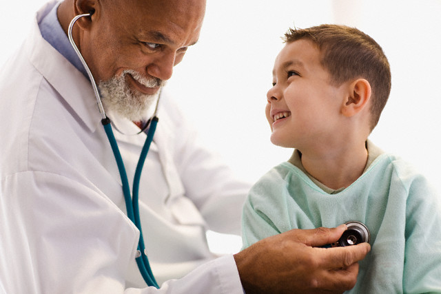 Pediatrician Giving Patient Checkup