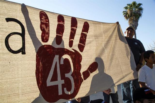 Familiares de los 43 estudiantes desaparecidos protestan en San Ysidro, California, cerca de la frontera de Estados Unidos con Mexico ayer, lunes 23 de marzo de 2015. La lucha de los padres de los 43 estudiantes desaparecidos hace casi seis meses en Iguala (México) llegó ayer a Washington, donde celebrarán una vigilia a las puertas del Departamento de Estado para pedir justicia a la comunidad internacional. Su llegada a Washington se enmarca dentro de la llamada "Caravana 43", una gira en la que los padres de los estudiantes recorrerán, por lo menos, 43 ciudades estadounidenses durante el próximo mes, entre las que está Nueva York. EFE/Eugene Garcia