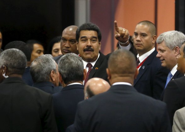 Venezuela's President Nicolas Maduro gestures as Canada's Prime Minister Stephen Harper (R)  stands near during the family photo of the VII Summit of the Americas in Panama City