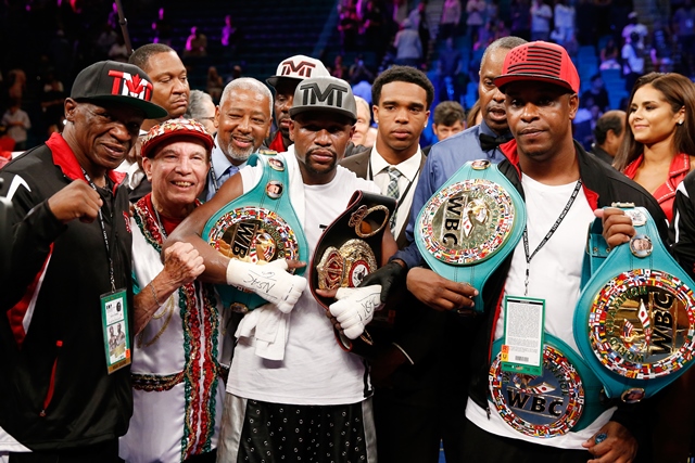 LAS VEGAS, NV - SEPTEMBER 12: (L-R) Floyd Mayweather Sr., Rafael Garcia, Floyd Mayweather Jr. and Blake DeJuan pose in the ring following their WBC/WBA welterweight title fight against Andre Berto at MGM Grand Garden Arena on September 12, 2015 in Las Vegas, Nevada. Mayweather won by unanimous decision.   Ezra Shaw/Getty Images/AFP