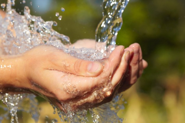 Woman's hands with water splash