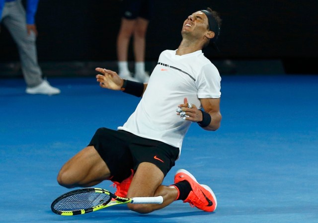 Tennis - Australian Open - Melbourne Park, Melbourne, Australia - early 28/1/17 Spain's Rafael Nadal falls onto the court as he celebrates winning his Men's singles semi-final match against Bulgaria's Grigor Dimitrov. REUTERS/Thomas Peter TPX IMAGES OF THE DAY