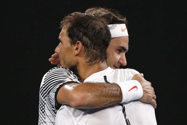 Tennis - Australian Open - Melbourne Park, Melbourne, Australia - 29/1/17  Switzerland's Roger Federer embraces after winning his Men's singles final match against Spain's Rafael Nadal. REUTERS/Issei Kato