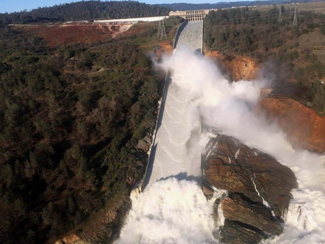 A damaged spillway with eroded hillside is seen in an aerial photo taken over the Oroville Dam in Oroville, California, U.S. February 11, 2017. California Department of Water Resources/William Croyle/Handout via REUTERS ATTENTION EDITORS - THIS IMAGE WAS PROVIDED BY A THIRD PARTY. EDITORIAL USE ONLY. THIS PICTURE WAS PROCESSED BY REUTERS TO ENHANCE QUALITY. AN UNPROCESSED VERSION HAS BEEN PROVIDED SEPARATELY.