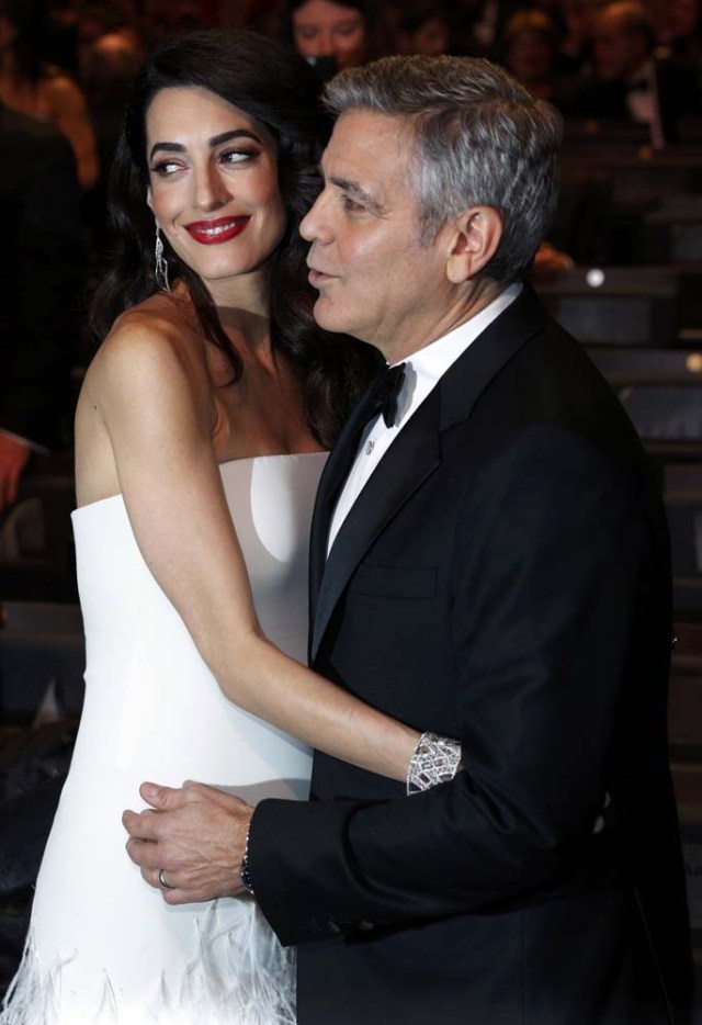 Actor George Clooney and his wife Amal pose before the start of the 42nd Cesar Awards ceremony in Paris, France, February 24, 2017.  REUTERS/Philippe Wojazer