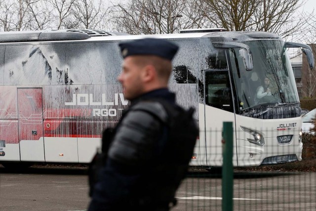 A French gendarme stands in front of a bus covered with white paint by demonstrators before a political rally of Marine Le Pen, French National Front (FN) political party leader and candidate for French 2017 presidential election, in Saint-Herblain near Nantes, France, February 26, 2017. REUTERS/Stephane Mahe