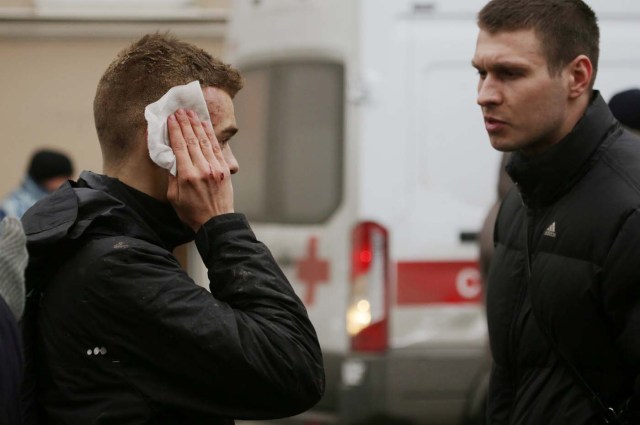 An injured person stands outside Sennaya Ploshchad metro station, following explosions in two train carriages at metro stations in St. Petersburg, Russia April 3, 2017. REUTERS/Anton Vaganov