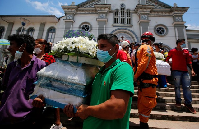 Family and friends carry victim coffins after flooding and mudslides caused by heavy rains leading several rivers to overflow, pushing sediment and rocks into buildings and roads in Mocoa, Colombia, April 4, 2017. REUTERS/Jaime Saldarriaga