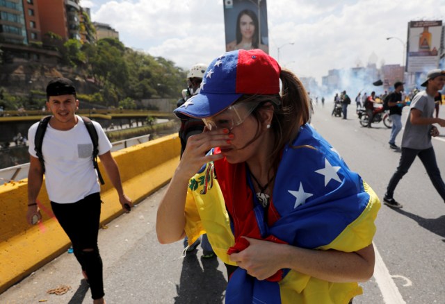 Demonstrators react while clashing with the riot police during a rally in Caracas, Venezuela, April 8, 2017. REUTERS/Carlos Garcia Rawlins