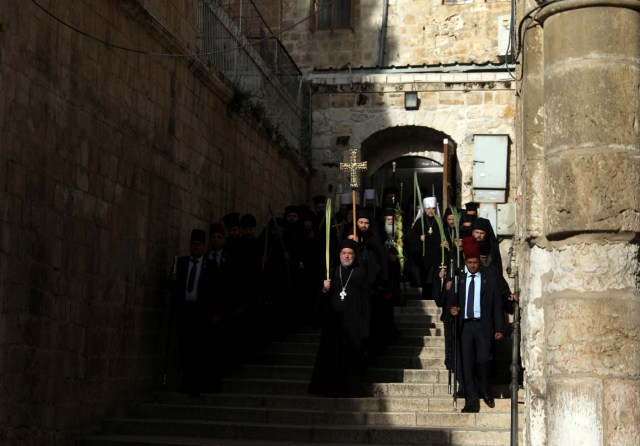 Members of the Orthodox Christian clergy take part in a Palm Sunday ceremony as they walk towards the Church of the Holy Sepulchre in Jerusalem's Old City April 9, 2017. REUTERS/Ammar Awad