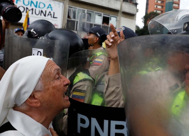 Elderly opposition supporters confront riot security forces while rallying against President Nicolas Maduro in Caracas, Venezuela, May 12, 2017. REUTERS/Carlos Garcia Rawlins