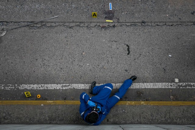 CAR26. CARACAS (VENEZUELA), 08/06/2017 - Trabajadores del Ministerio Público realizan hoy, jueves 8 de junio de 2017, el levantamiento planimétrico en el lugar en el que un joven de 17 años murió durante una protesta opositora, en Caracas (Venezuela). El Ministerio Público venezolano (MP, Fiscalía) cifró hoy en 67 las muertes registradas en hechos violentos relacionados con las protestas a favor y en contra del Gobierno de Nicolás Maduro que sacuden la nación desde hace 69 días. EFE/MIGUEL GUTIÉRREZ