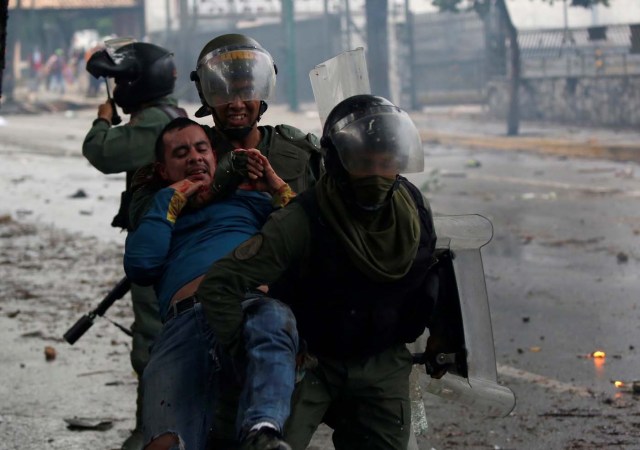 ATTENTION EDITORS - VISUAL COVERAGE OF SCENES OF DEATH AND INJURY      Riot security forces detain a demonstrator during a rally against Venezuela's President Nicolas Maduro's government in Caracas, Venezuela, July 28, 2017. REUTERS/Carlos Garcia Rawlins