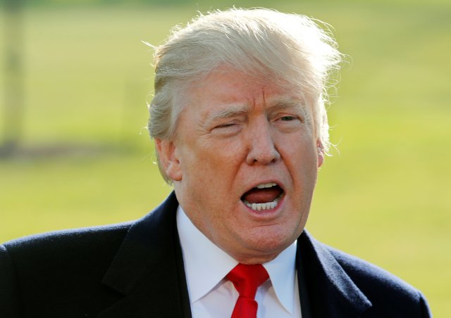 FILE PHOTO: U.S. President Donald Trump talks to reporters before departing the White House for a visit to the Walter Reed Medical Center in Washington, DC, U.S., December 21, 2017. REUTERS/Jim Bourg/File Photo