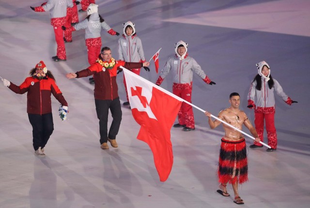 Pyeongchang 2018 Winter Olympics – Opening ceremony – Pyeongchang Olympic Stadium - Pyeongchang, South Korea – February 9, 2018 - Pita Taufatofua of Tonga carries the national flag. REUTERS/Carlos Barria