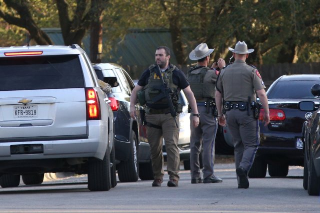 Law enforcement personnel investigate the surroundings of a house linked to the bomber in Pflugerville, Texas, U.S., March 21, 2018. REUTERS/Loren Elliott