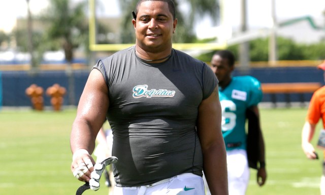Miami Dolphins tackle Jonathan Martin walks off the field after an NFL football practice, Wednesday, July 24, 2013, in Davie, Fla. The offensive line looks different in training camp, with changes at both tackle spots. Jonathan Martin is now on the left side, and No. 77 is no longer Jake Long. (AP Photo/Lynne Sladky)